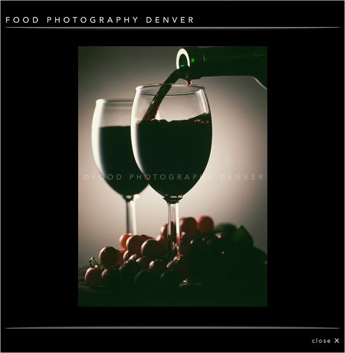 Pouring Red Wine with Grapes